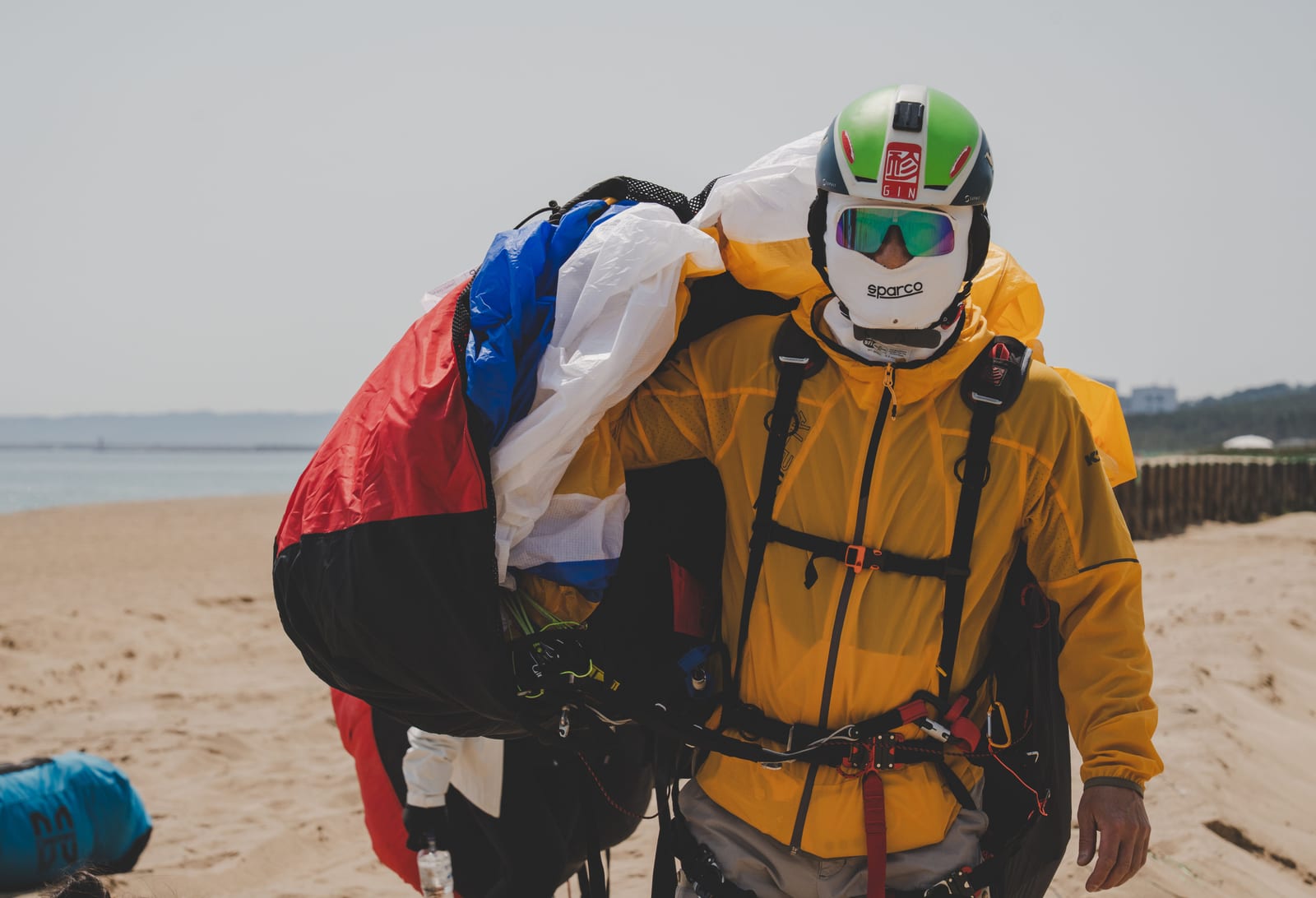 A packed parachute rig on the ground at a dropzone.